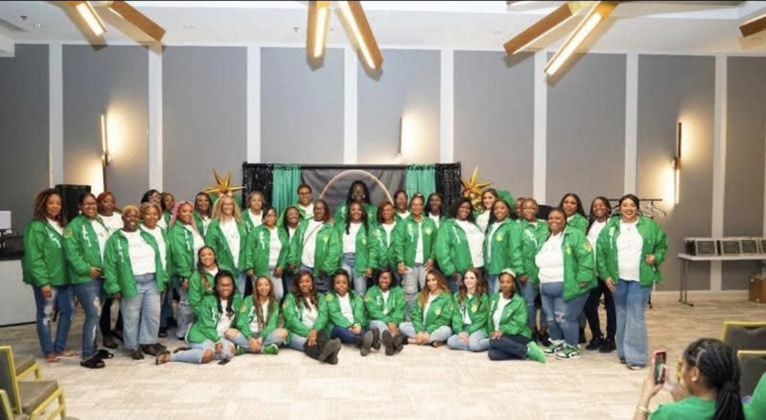 Sisterhood Circle members gathered together in darker green jackets